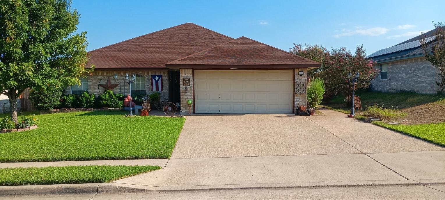 Ranch home brown shingle roof Texas star flag Nolanville TX roofing contractor Martinez Construction